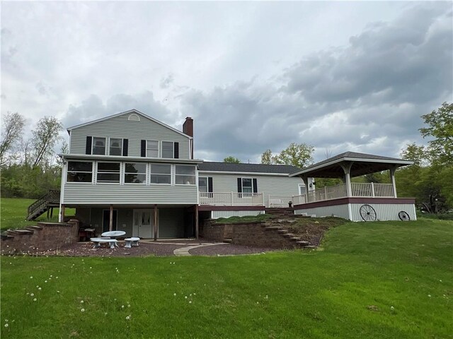8584 Vieley Rd, Campbell, NY 14821 - rear view of house with stairway, a chimney, a sunroom, and a yard