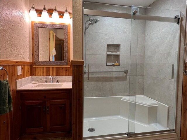 8584 Vieley Rd, Campbell, NY 14821 - full bathroom with a stall shower, a textured wall, vanity, a wainscoted wall, and wood walls