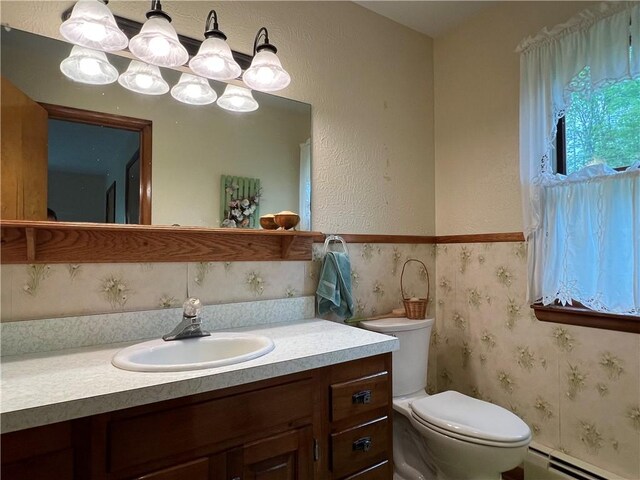 8584 Vieley Rd, Campbell, NY 14821 - half bathroom featuring baseboard heating, vanity, toilet, and a textured wall