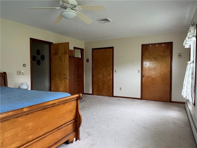 8584 Vieley Rd, Campbell, NY 14821 - bedroom with a baseboard heating unit, light carpet, baseboards, and multiple closets