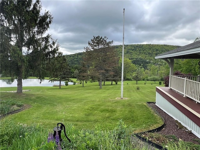 8584 Vieley Rd, Campbell, NY 14821 - view of grassy yard featuring a wooded view and a deck with water view