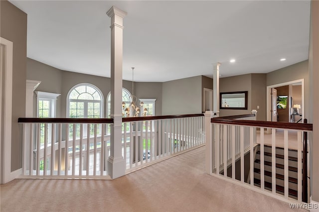 hallway with carpet floors, recessed lighting, and a chandelier