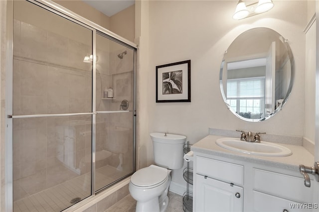 full bath with a stall shower, toilet, vanity, tile patterned floors, and baseboards