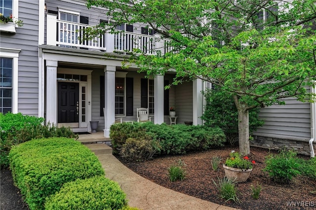 entrance to property with a balcony and covered porch