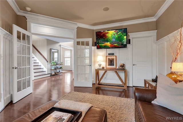 living area featuring french doors, crown molding, stairs, and wood finished floors