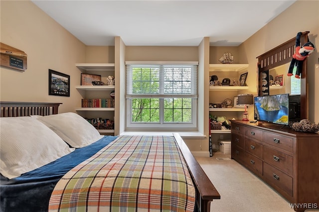 bedroom featuring light carpet