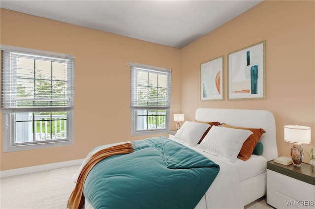 bedroom with baseboards and light carpet