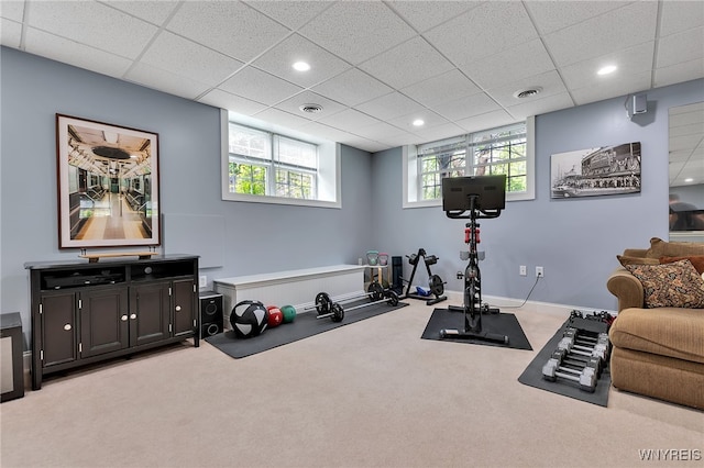 workout room featuring light carpet, a paneled ceiling, baseboards, and recessed lighting