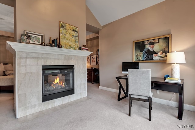 office space with carpet floors, a fireplace, baseboards, and vaulted ceiling