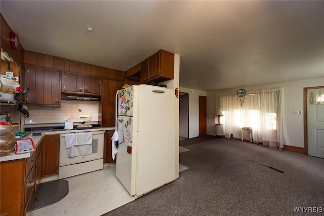 7233 Ridge Rd, Newfane, NY 14094 - kitchen with white appliances, under cabinet range hood, decorative backsplash, light countertops, and brown cabinets