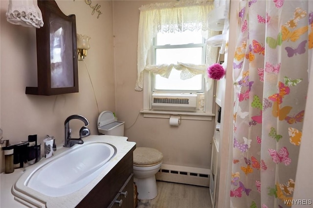 7233 Ridge Rd, Newfane, NY 14094 - full bath with a baseboard radiator, toilet, vanity, wood finished floors, and curtained shower