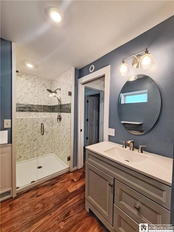 55 Washington Ave, Pomfret, NY 14063 - bathroom featuring a stall shower, wood finished floors, and vanity