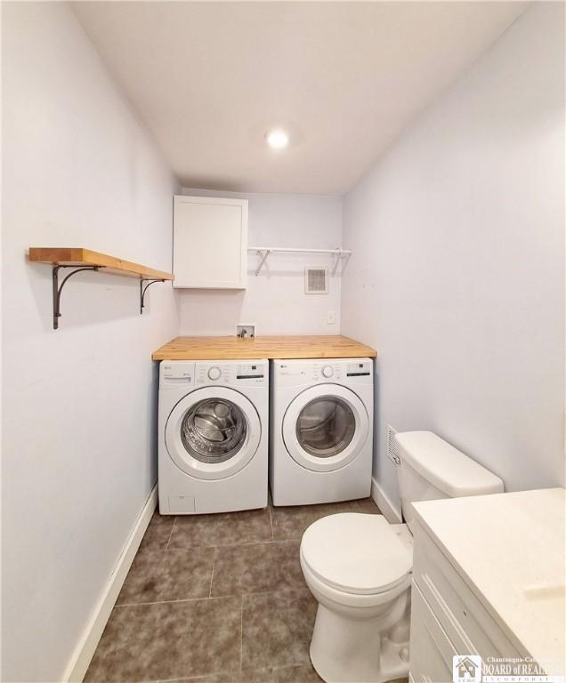 55 Washington Ave, Pomfret, NY 14063 - clothes washing area with separate washer and dryer, baseboards, and dark tile patterned flooring