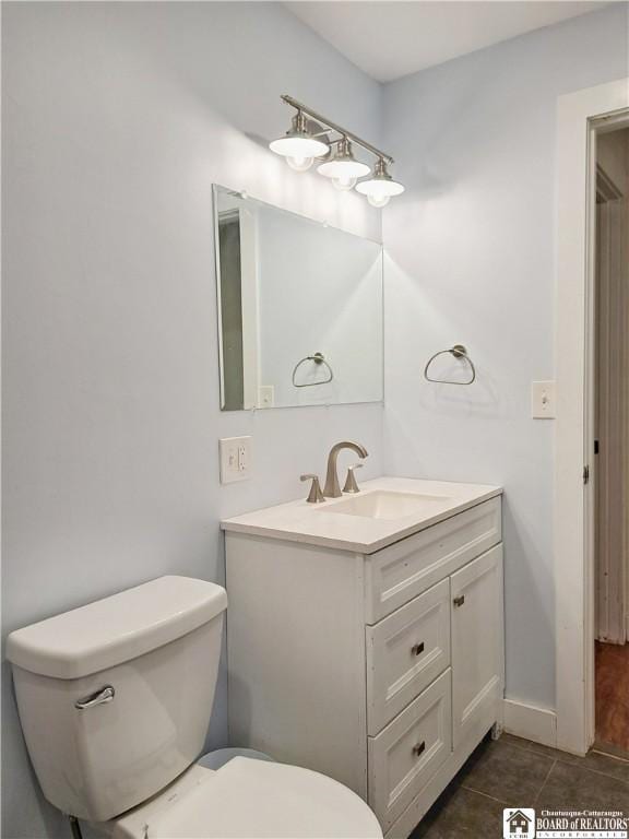 55 Washington Ave, Pomfret, NY 14063 - bathroom with toilet, vanity, and tile patterned floors