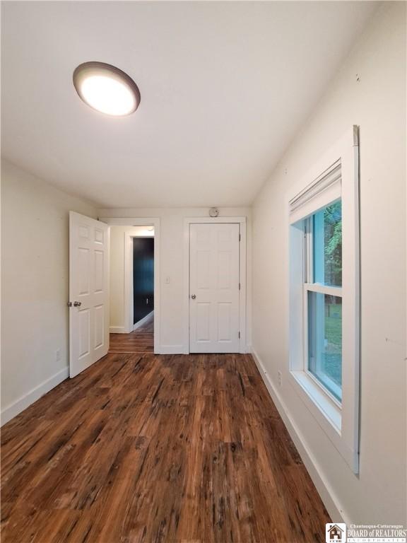 55 Washington Ave, Pomfret, NY 14063 - unfurnished bedroom with wood finished floors and baseboards