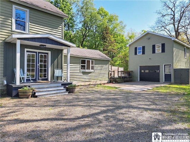 55 Washington Ave, Pomfret, NY 14063 - view of side of property featuring driveway, a garage, and board and batten siding