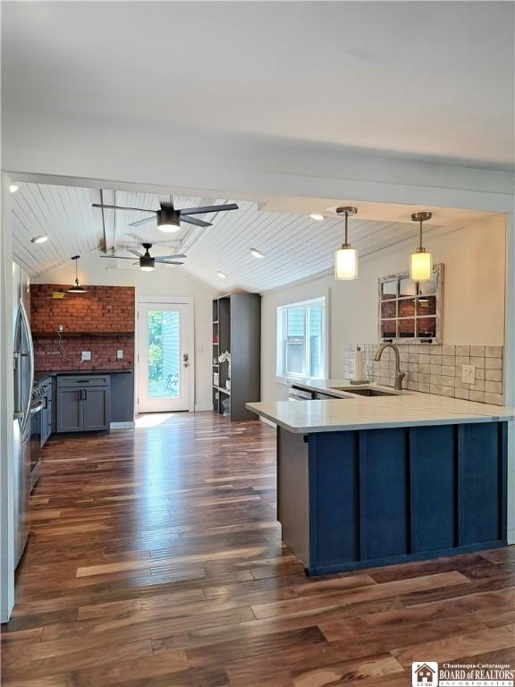 55 Washington Ave, Pomfret, NY 14063 - kitchen with a sink, a peninsula, dark wood-type flooring, tasteful backsplash, and pendant lighting