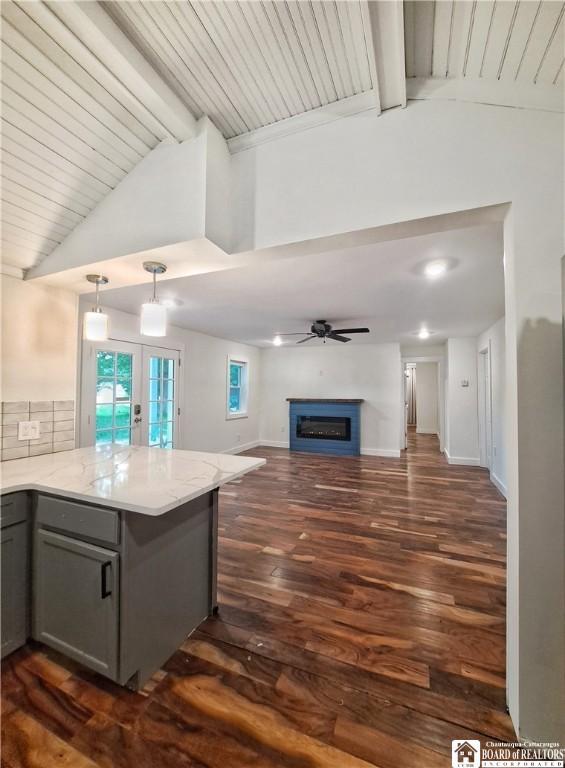 55 Washington Ave, Pomfret, NY 14063 - kitchen with gray cabinetry, open floor plan, a peninsula, beamed ceiling, and a fireplace