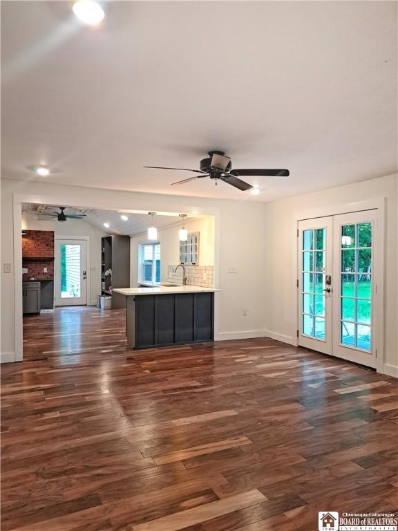 55 Washington Ave, Pomfret, NY 14063 - unfurnished living room with a ceiling fan, french doors, dark wood-style floors, baseboards, and lofted ceiling