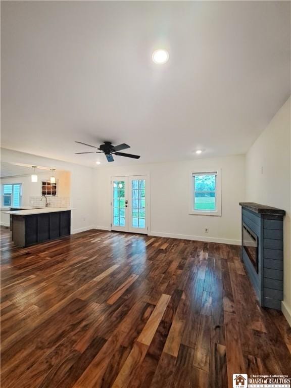 55 Washington Ave, Pomfret, NY 14063 - unfurnished living room with a glass covered fireplace, healthy amount of natural light, dark wood-style floors, ceiling fan, and recessed lighting