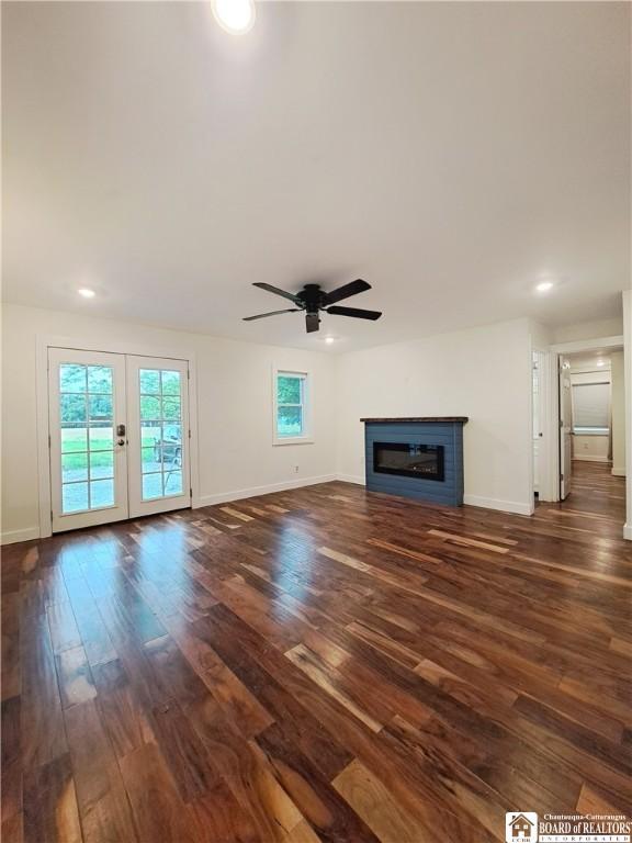 55 Washington Ave, Pomfret, NY 14063 - unfurnished living room with dark wood-style floors, ceiling fan, a glass covered fireplace, baseboards, and recessed lighting