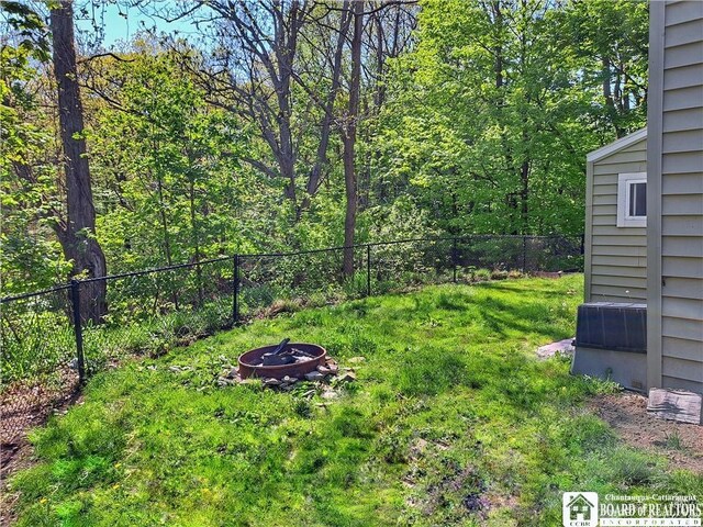 55 Washington Ave, Pomfret, NY 14063 - view of yard featuring a fire pit and fence