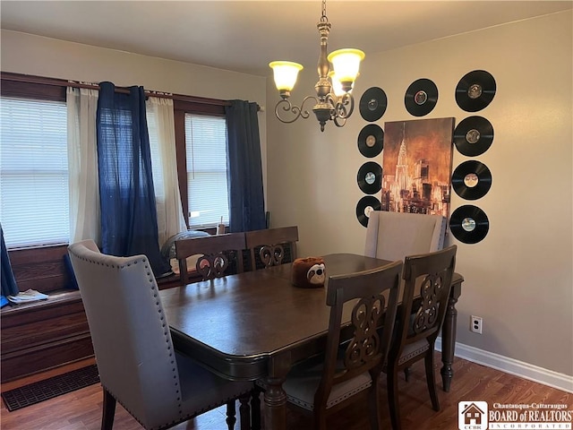 417 Charles St, Jamestown, NY 14701 - dining space with a chandelier, wood finished floors, and baseboards