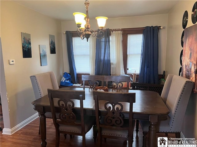 417 Charles St, Jamestown, NY 14701 - dining area with a chandelier, baseboards, and wood finished floors