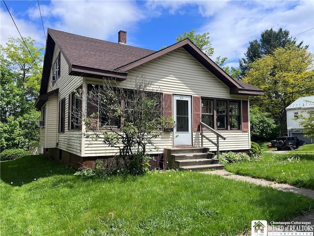 417 Charles St, Jamestown, NY 14701 - bungalow-style house featuring entry steps, a shingled roof, a chimney, and a front lawn