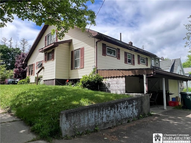 417 Charles St, Jamestown, NY 14701 - view of home's exterior with a chimney and a lawn