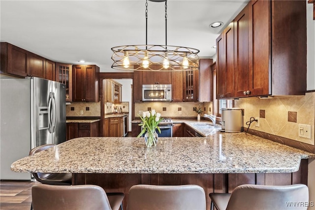 60 Kettle Run, Elma, NY 14052 - kitchen with appliances with stainless steel finishes, a peninsula, glass insert cabinets, light stone countertops, and recessed lighting