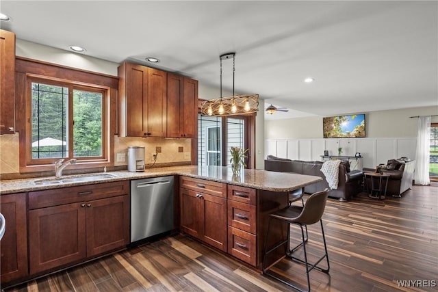60 Kettle Run, Elma, NY 14052 - kitchen featuring stainless steel dishwasher, a peninsula, dark wood finished floors, a breakfast bar, and wainscoting