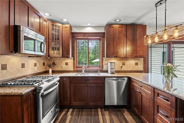 60 Kettle Run, Elma, NY 14052 - kitchen featuring appliances with stainless steel finishes, dark wood-type flooring, light stone countertops, glass insert cabinets, and decorative backsplash
