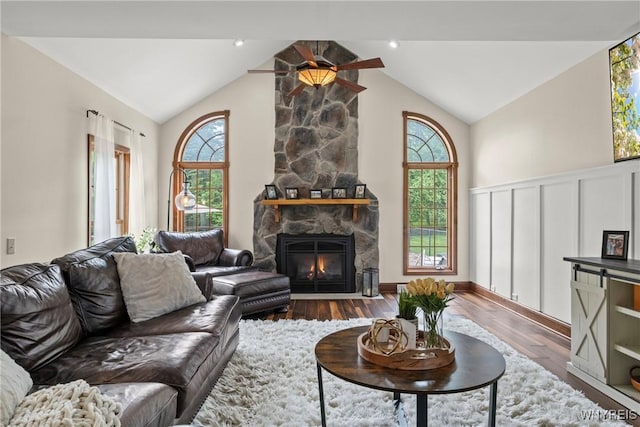 60 Kettle Run, Elma, NY 14052 - living room with plenty of natural light, wood finished floors, a stone fireplace, and high vaulted ceiling