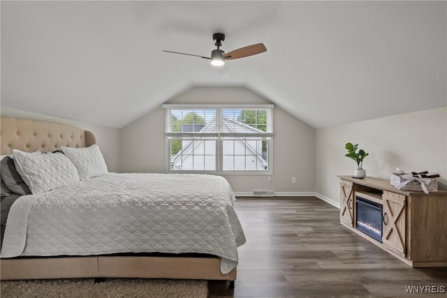 60 Kettle Run, Elma, NY 14052 - bedroom with dark wood-type flooring, lofted ceiling, ceiling fan, and a glass covered fireplace