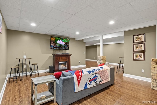 60 Kettle Run, Elma, NY 14052 - living room with a lit fireplace, wood finished floors, and a drop ceiling