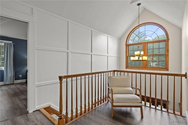 60 Kettle Run, Elma, NY 14052 - sitting room with a decorative wall, vaulted ceiling, and wood finished floors