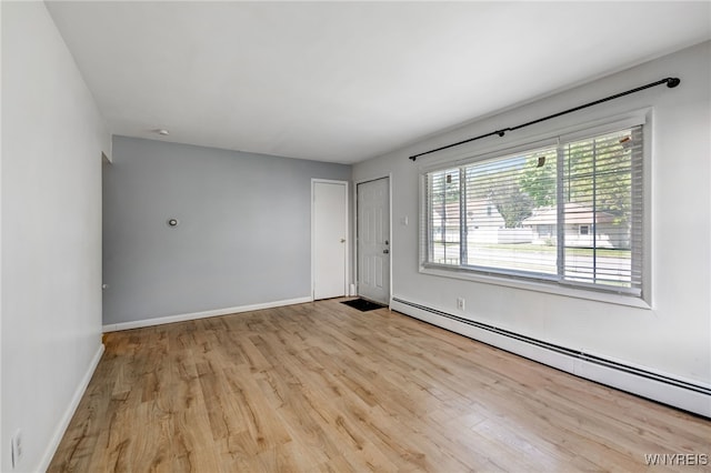 4233 Crescent Dr, Niagara Falls, NY 14305 - spare room with baseboard heating, wood finished floors, and baseboards