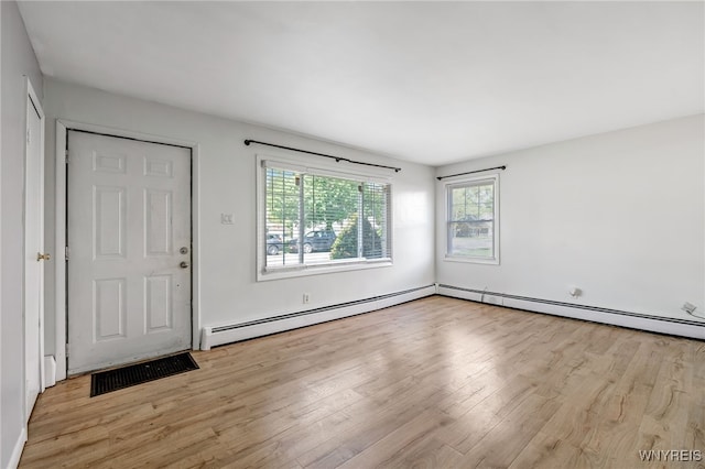 4233 Crescent Dr, Niagara Falls, NY 14305 - entrance foyer with a baseboard heating unit, wood finished floors, and plenty of natural light