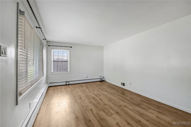 4233 Crescent Dr, Niagara Falls, NY 14305 - unfurnished bedroom with a baseboard radiator, wood finished floors, and baseboards