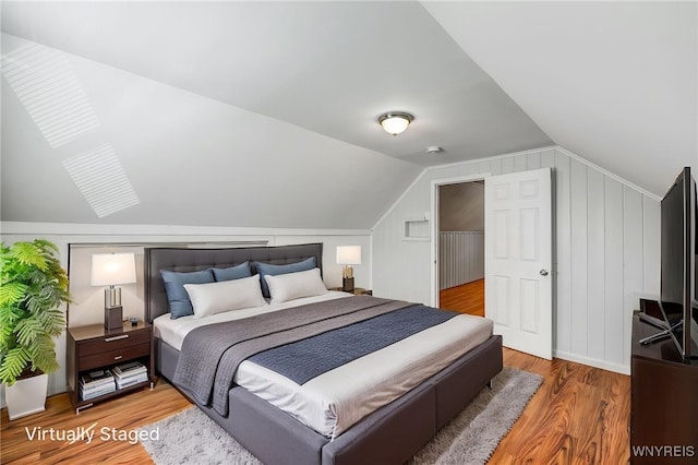 4233 Crescent Dr, Niagara Falls, NY 14305 - bedroom featuring wood finished floors and vaulted ceiling
