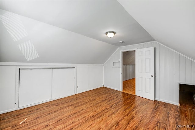4233 Crescent Dr, Niagara Falls, NY 14305 - bonus room featuring lofted ceiling, wood finished floors, baseboards, a decorative wall, and a skylight