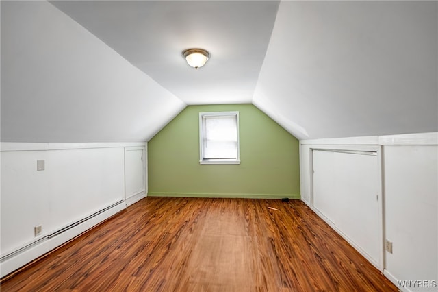 4233 Crescent Dr, Niagara Falls, NY 14305 - bonus room featuring a baseboard heating unit, wood finished floors, and lofted ceiling