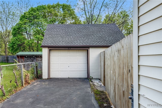 4233 Crescent Dr, Niagara Falls, NY 14305 - detached garage featuring asphalt driveway and fence
