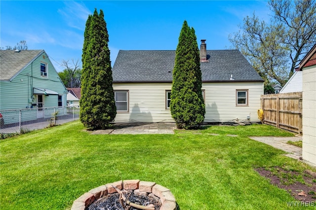4233 Crescent Dr, Niagara Falls, NY 14305 - rear view of house with a fire pit, a patio area, a chimney, and roof with shingles