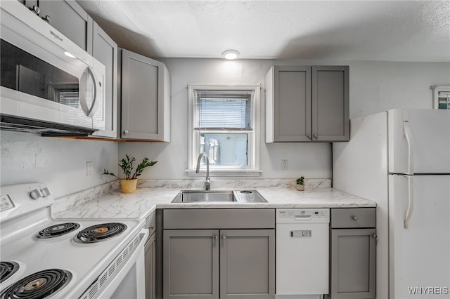 4233 Crescent Dr, Niagara Falls, NY 14305 - kitchen with white appliances, gray cabinets, a sink, and light stone counters