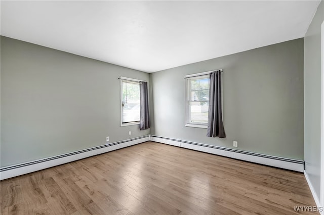 4233 Crescent Dr, Niagara Falls, NY 14305 - spare room with wood finished floors, baseboard heating, a baseboard heating unit, and baseboards