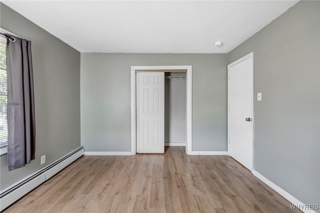 4233 Crescent Dr, Niagara Falls, NY 14305 - unfurnished bedroom featuring a baseboard radiator, wood finished floors, baseboards, and a closet