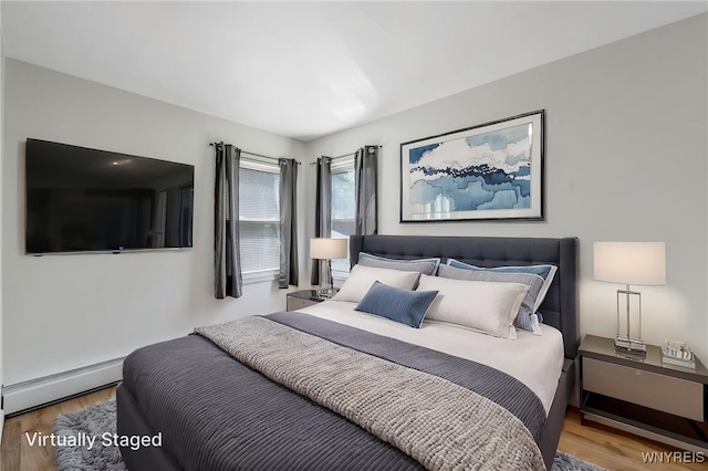 4233 Crescent Dr, Niagara Falls, NY 14305 - bedroom with baseboard heating and wood finished floors