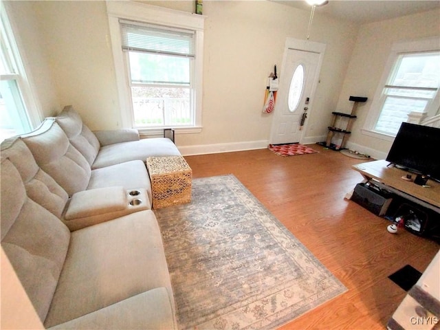 living room featuring wood finished floors and baseboards